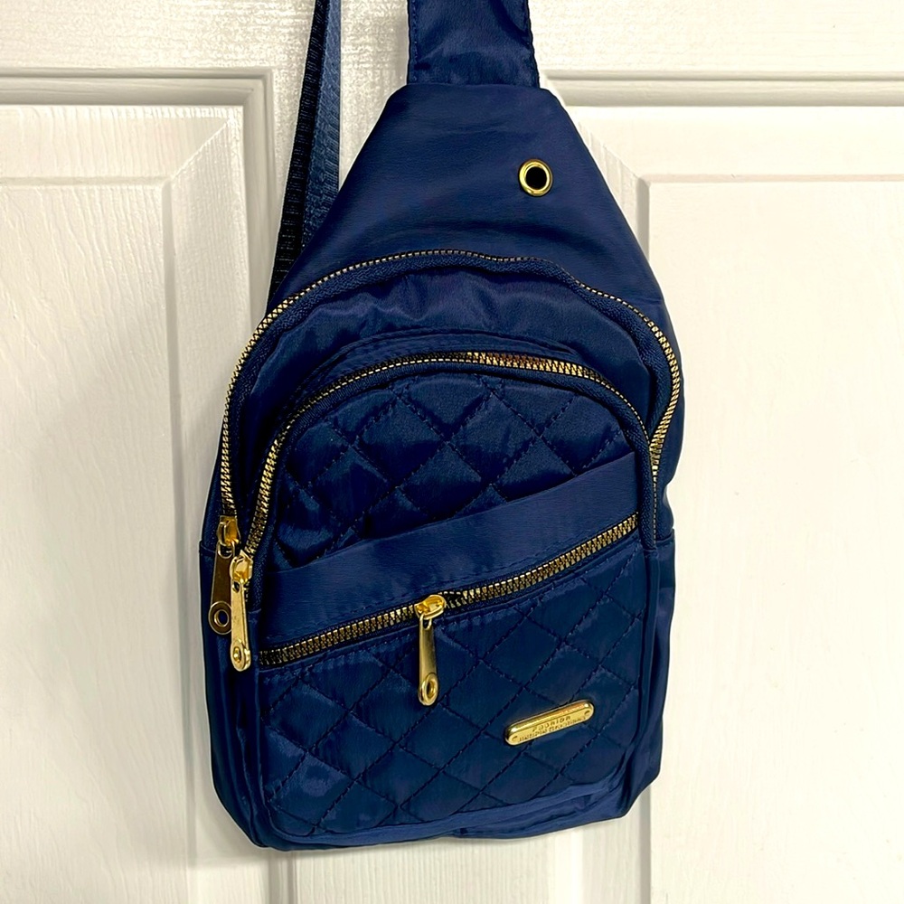 Bright royal bluee crossbody bag with 3 zippered compartments. Adjustable strap.